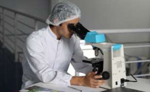 A health worker using a microscope